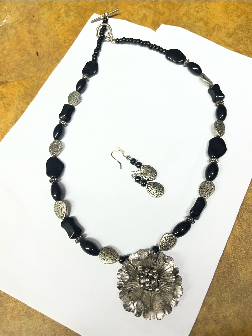 Handcrafted Black Bead Necklace with Silver Floral Pendant